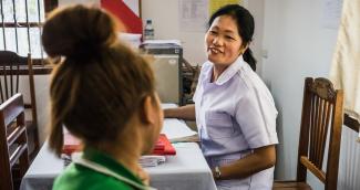 A nurse provides counselling on sexually transmitted infections (STIs) to a female sex worker